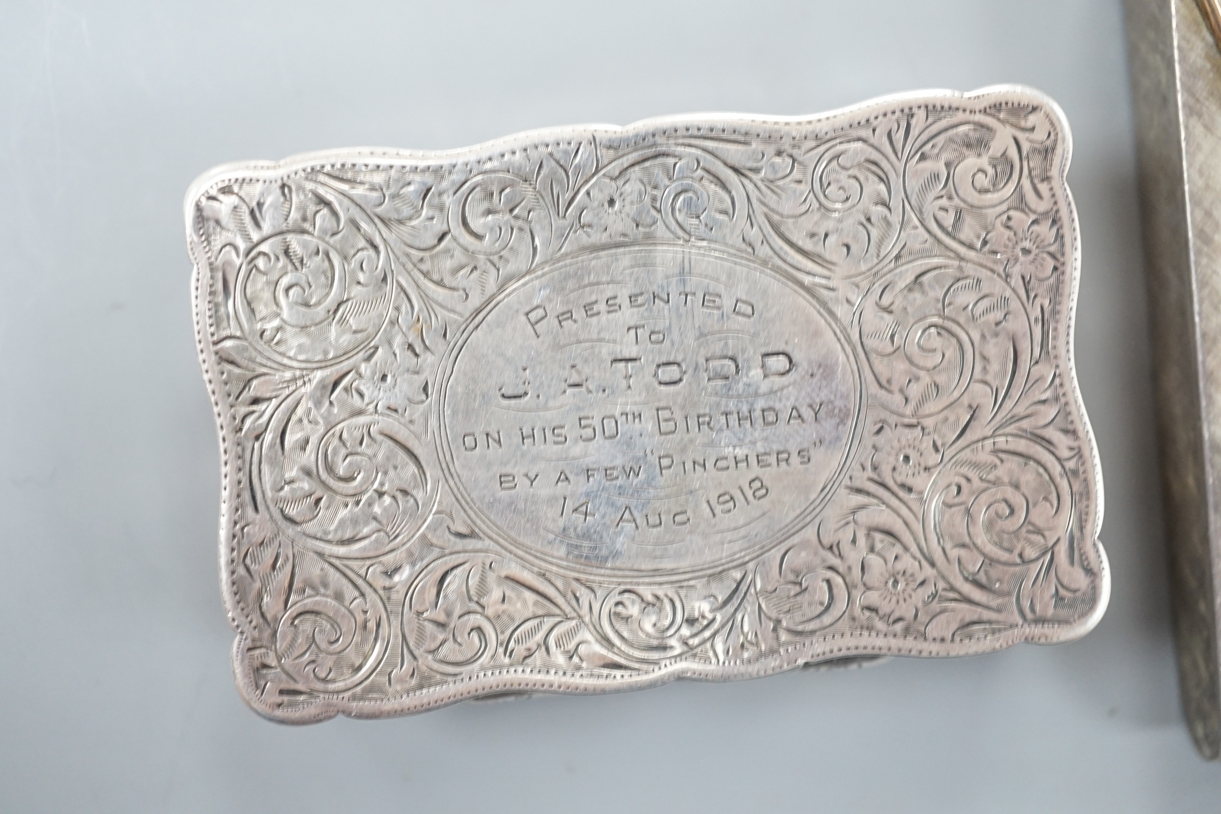 A George V engraved silver snuff box, Joseph Gloster Ltd, Birmingham, 1913, 71mm, with engraved inscription, together with and Italian brushed 925 and 750 cigarette case.
